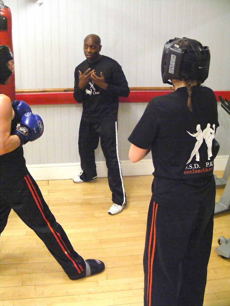 Rob shows a pair of students self defence techniques giving them a real lfe situation example